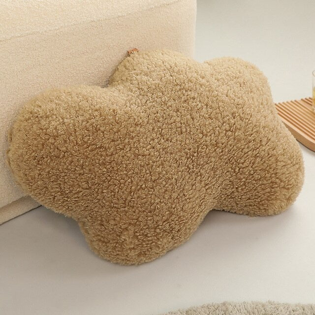 a taupe colored cloud-shaped pillow