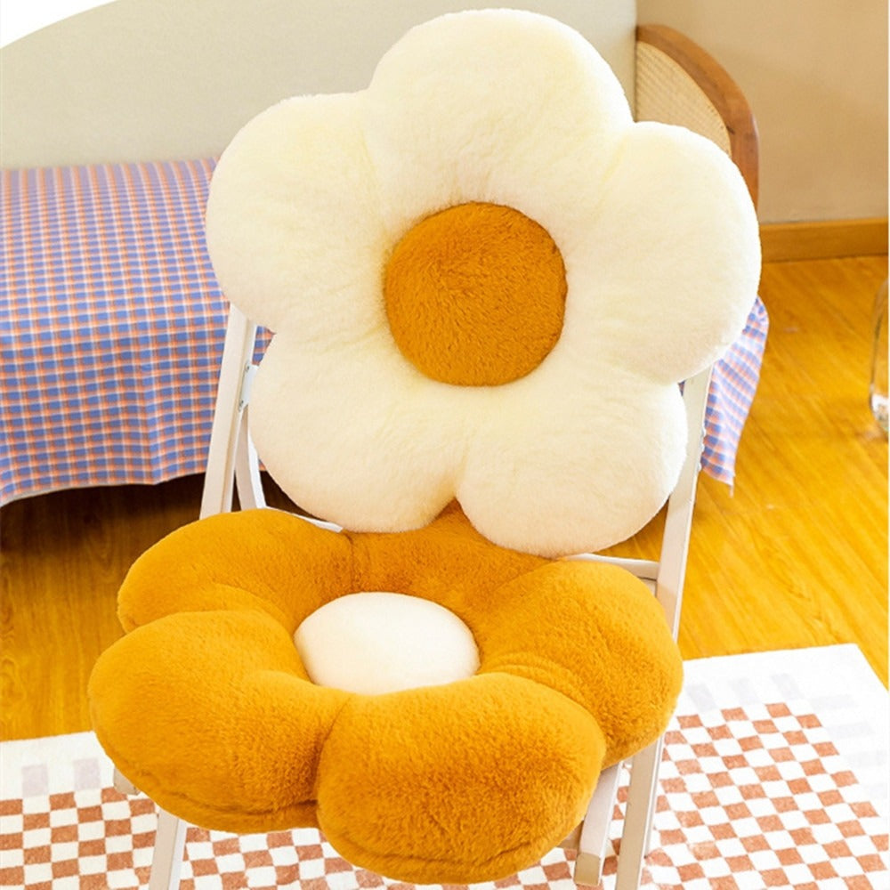 Two flower-shaped cushion pillows on a chair